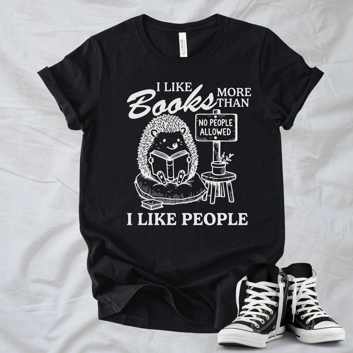 Unisex Zeke Squad T-shirt with the phrase “I Like Books More Than People” featuring a funny animal holding a “No People” sign.