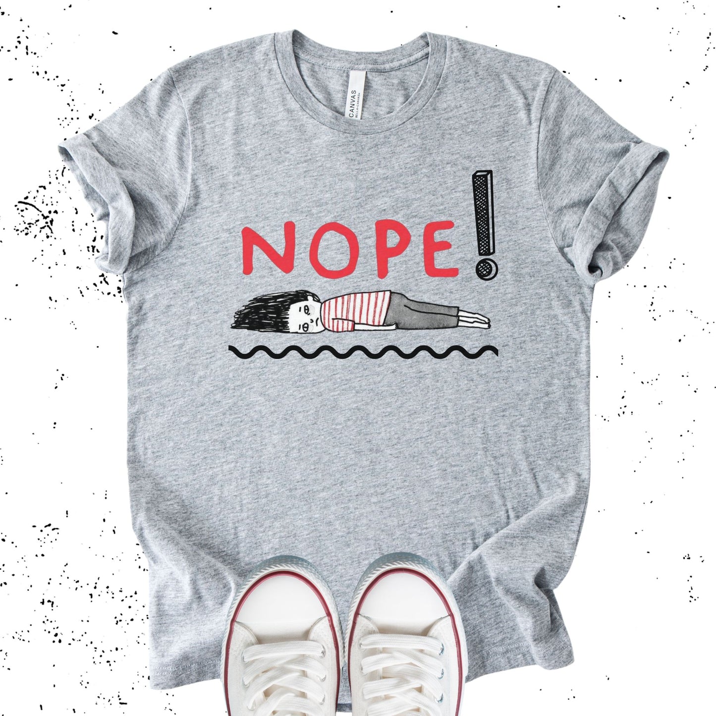 Unisex Zeke Squad T-shirt with the phrase “Nope” and a graphic of a woman lying flat, representing burnout and exhaustion.