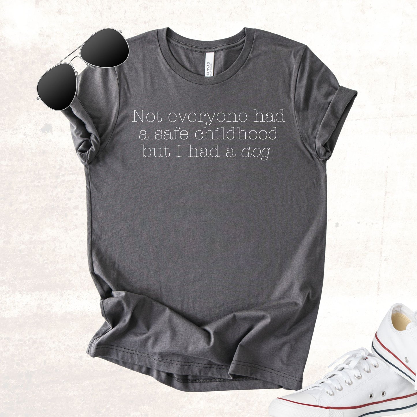 Unisex Zeke Squad T-shirt with the phrase “Not everyone had a safe childhood, but we had a dog” for survivors and dog lovers.
