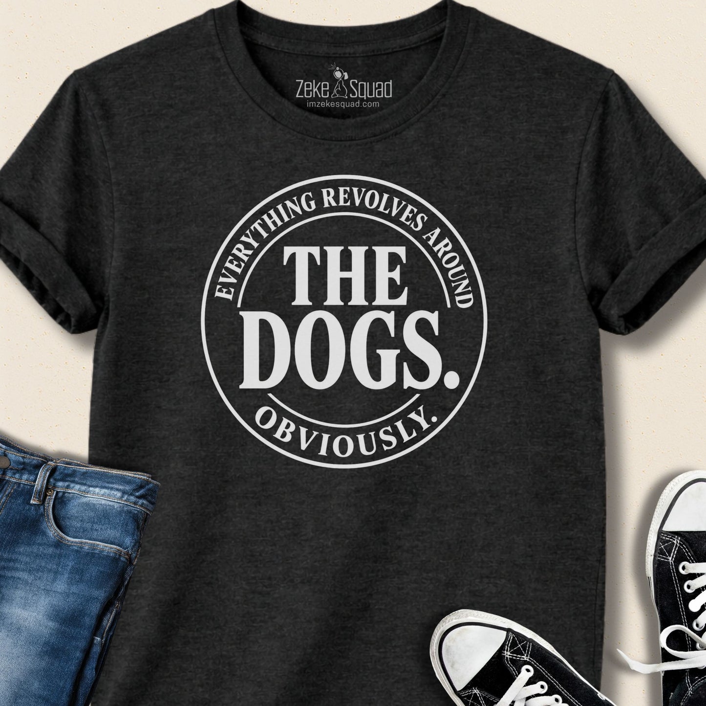 Black heather unisex graphic tee with a round emblem reading everything revolves around the dogs obviously, Bella Canvas 3001