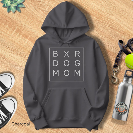 Dark gray hoodie with 'BXR DOG MOM' text on a wooden surface with accessories.