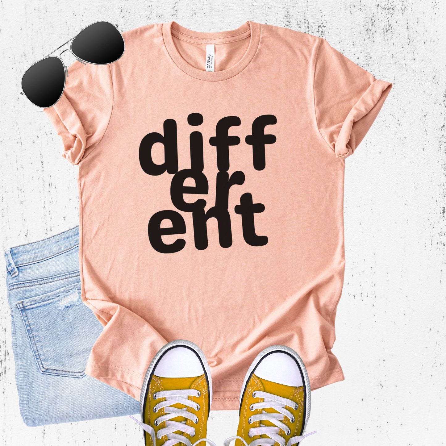 Unisex Zeke Squad T-shirt with the word “Different,” featuring flipped or altered letters as a statement for misfits and neurodivergent humans.