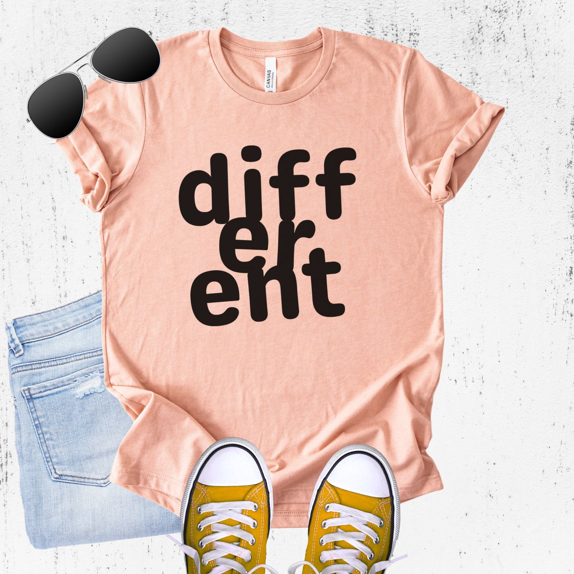 Unisex Zeke Squad T-shirt with the word “Different,” featuring flipped or altered letters as a statement for misfits and neurodivergent humans.