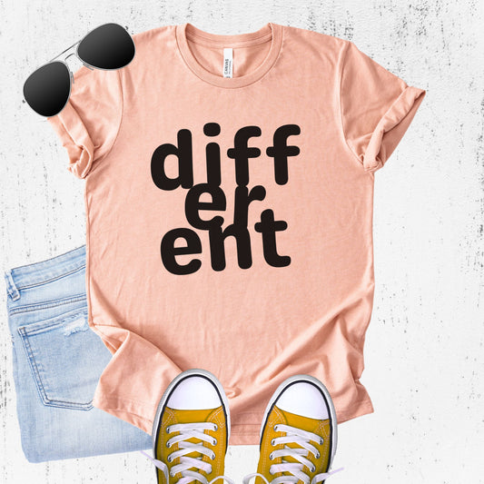 Unisex Zeke Squad T-shirt with the word “Different,” featuring flipped or altered letters as a statement for misfits and neurodivergent humans.