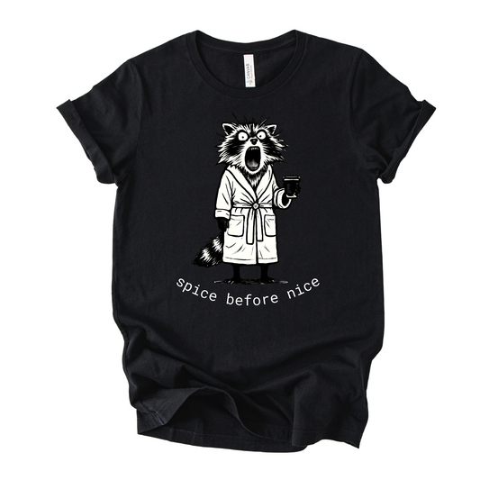 Unisex Zeke Squad T-shirt with a graphic of a grouchy raccoon in a robe holding a coffee mug, hair standing up, looking chaotic.
