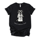 Unisex Zeke Squad T-shirt with a graphic of a grouchy raccoon in a robe holding a coffee mug, hair standing up, looking chaotic.