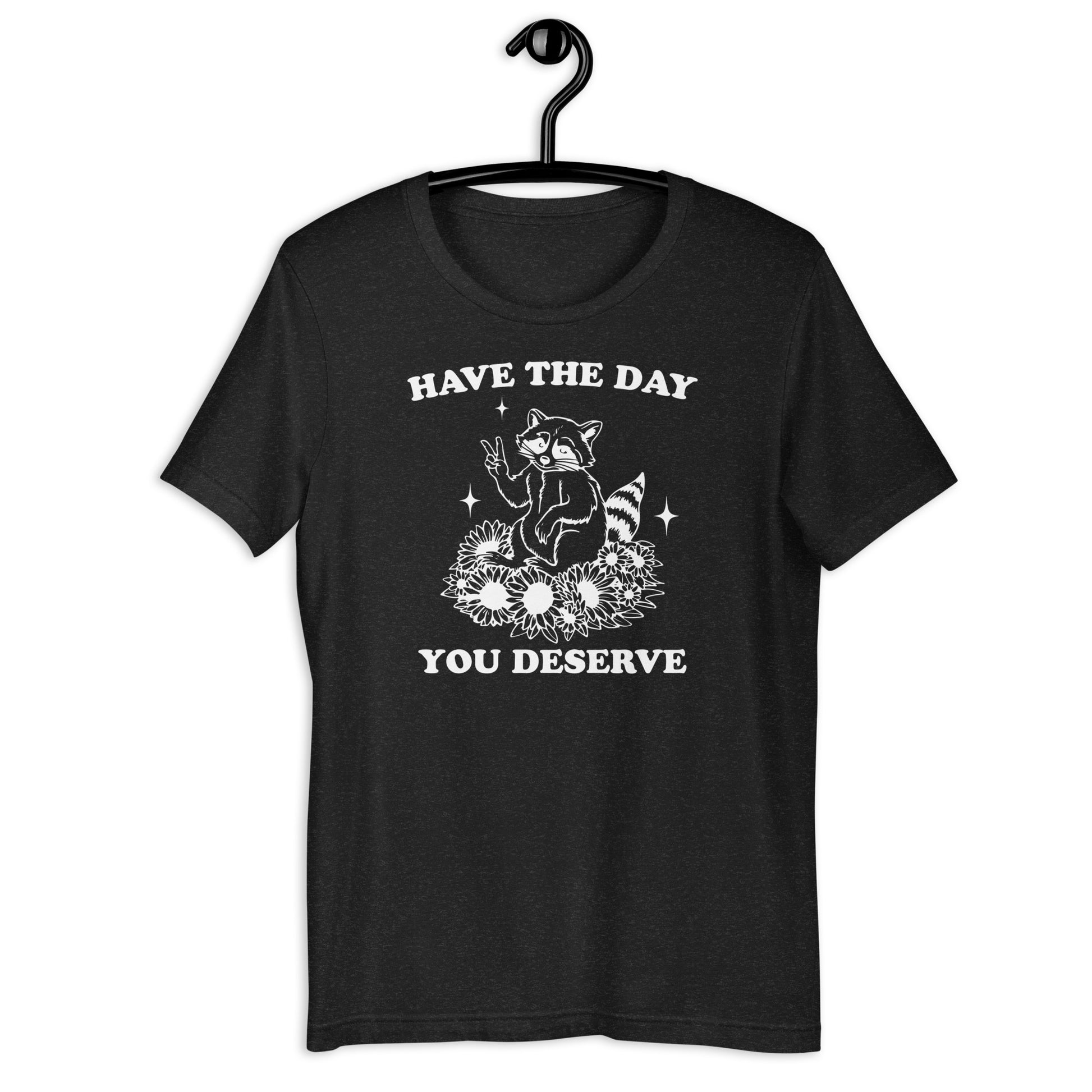 Unisex Zeke Squad T-shirt with the sarcastic phrase “Have the Day You Deserve” and a funny raccoon graphic.