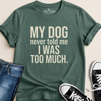 Green t-shirt with humorous text design, paired with jeans and sneakers on a neutral background.