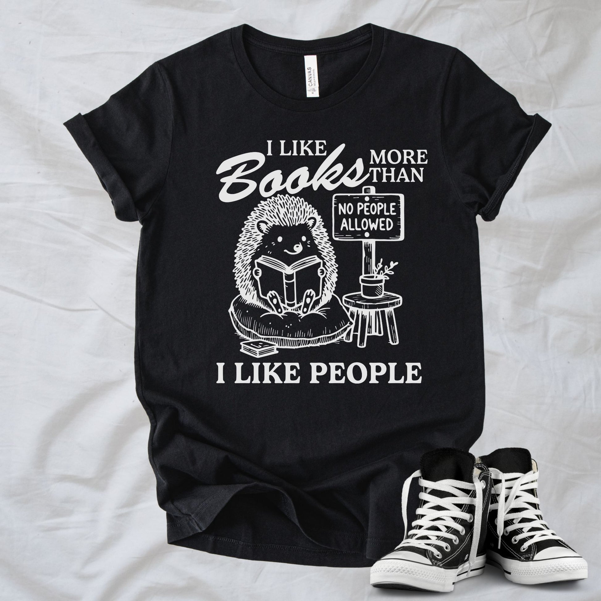 Unisex Zeke Squad T-shirt with the phrase “I Like Books More Than People” featuring a funny animal holding a “No People” sign.