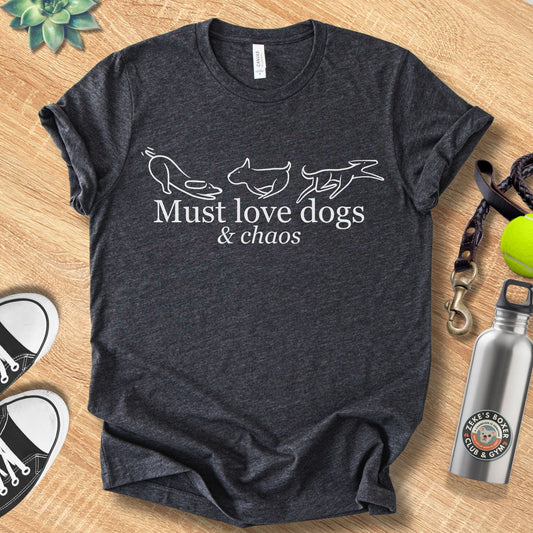 Unisex Zeke Squad t-shirt with the phrase “Must Love Dogs and Chaos,” a funny, relatable design for dog lovers.