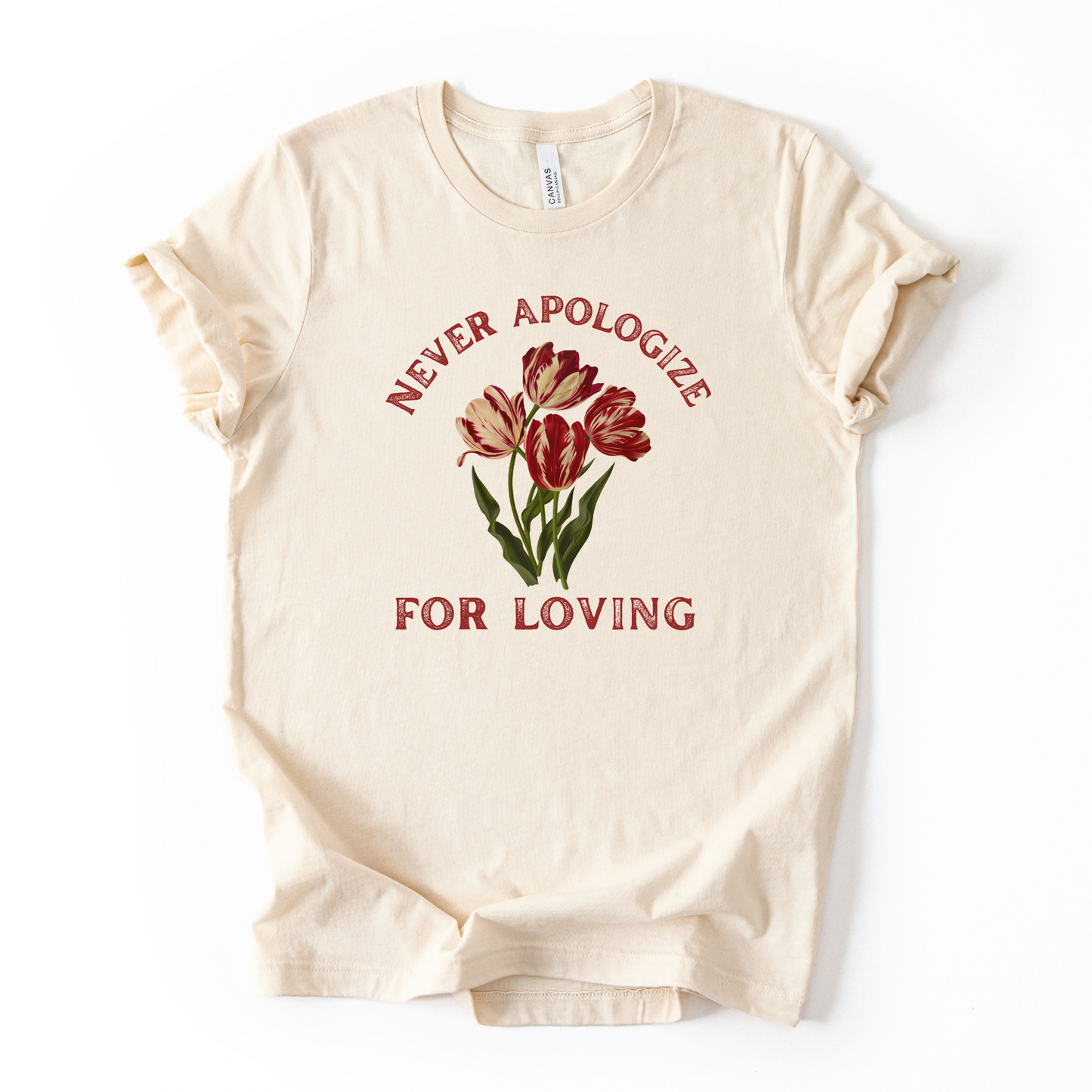 Beige t-shirt with red tulips and text 'Never apologize for loving' on a white background. Love is love.