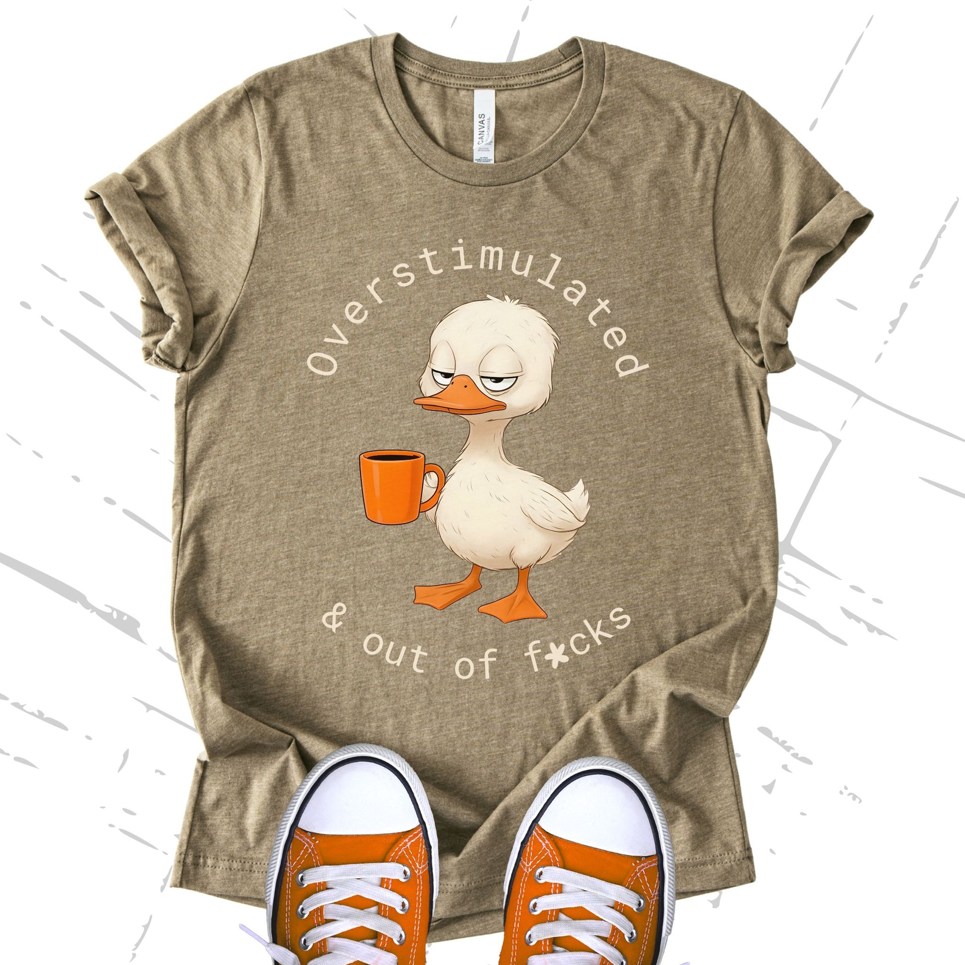 Unisex Zeke Squad T-shirt with the phrase “Overstimulated and Out of Fucks” featuring a duck holding a cup of coffee.