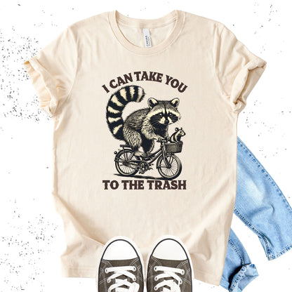 Unisex Zeke Squad T-shirt with a vintage-style graphic of a raccoon riding a bike and the phrase “I can take you to the trash.