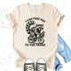 Unisex Zeke Squad T-shirt with a vintage-style graphic of a raccoon riding a bike and the phrase “I can take you to the trash.