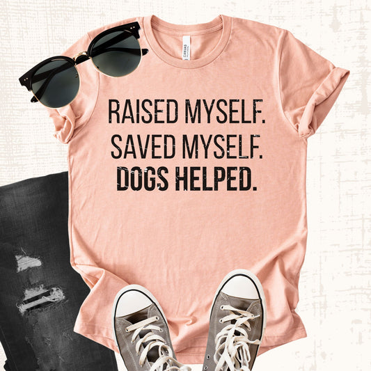 Unisex Zeke Squad T-shirt with the phrase “Raised myself. Saved myself. Dogs helped” for survivors and dog lovers.