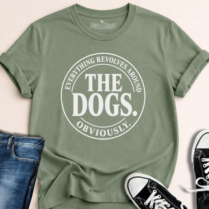 Sage green unisex graphic tee with a round emblem reading everything revolves around the dogs obviously, Bella Canvas 3001