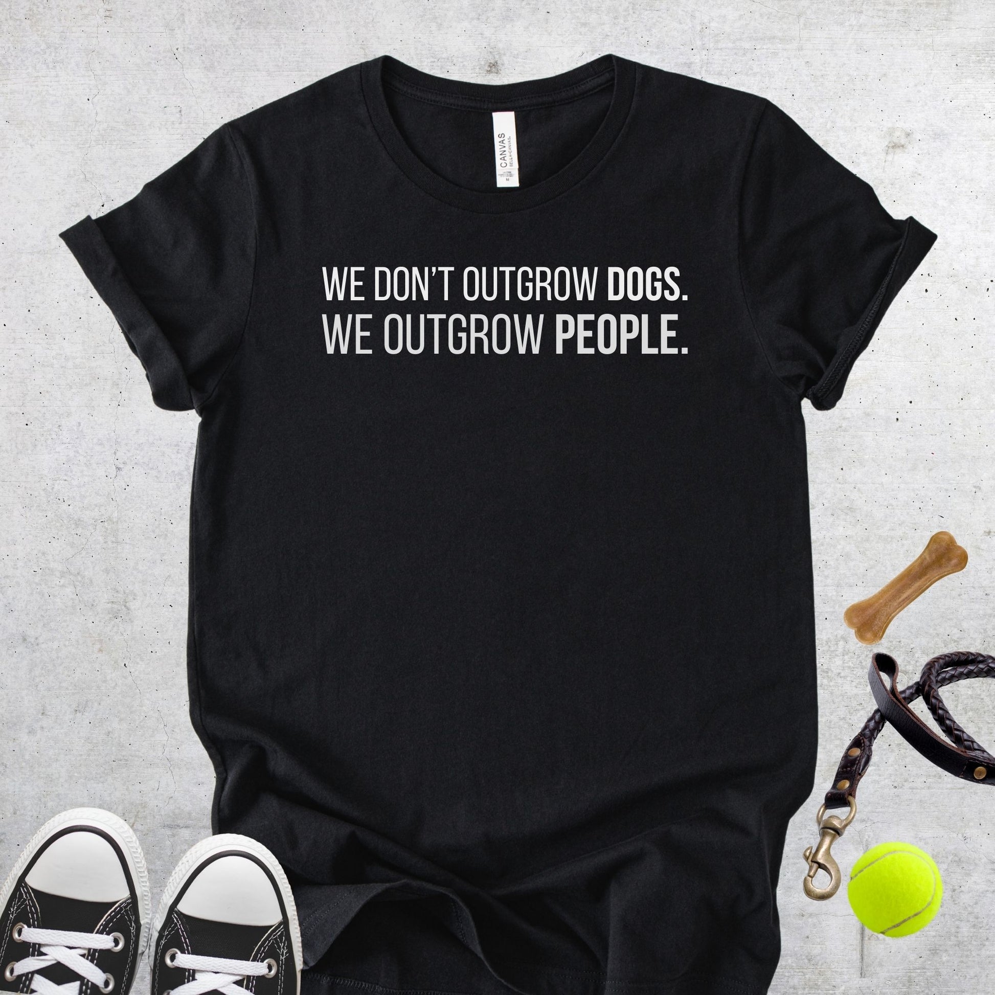 Unisex Zeke Squad T-shirt with the quote “We don’t outgrow dogs, we outgrow people” for dog lovers.
